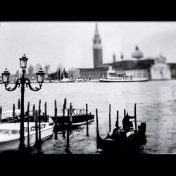 Boats in river with buildings in background