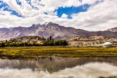 Scenic view of lake and mountains against sky