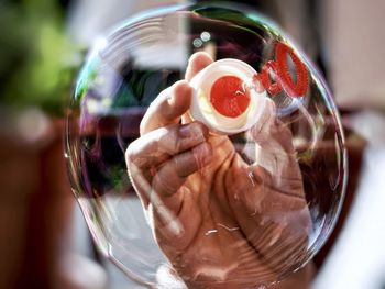 Close-up of hand holding ice cream glass