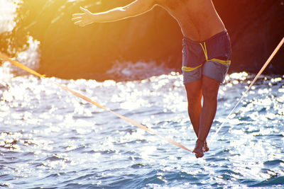 Low section of man in sea