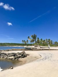 Scenic view of beach against blue sky