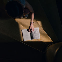 High angle view of woman reading book