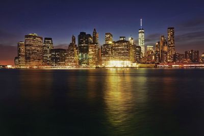 River with illuminated buildings in distance