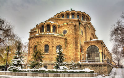 Low angle view of historic building against sky during winter
