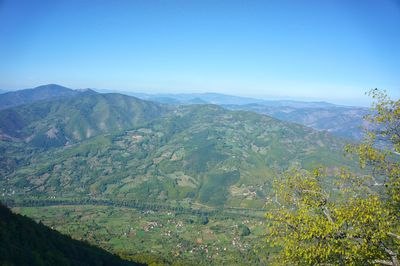 Scenic view of mountains against clear blue sky