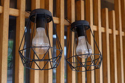 Close-up of light bulbs against wall at home