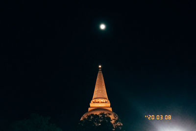 Low angle view of illuminated building against sky at night