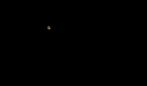 Low angle view of moon against sky at night