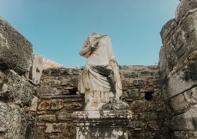 Low angle view of statue against sky