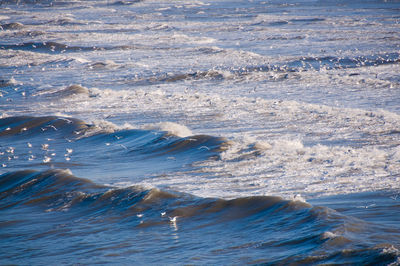 High angle view of waves rushing towards shore