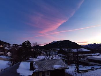 Scenic view of snowcapped mountains against sky during sunset