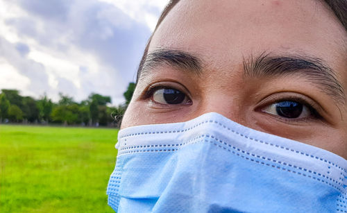 Close-up portrait of woman wearing mask outdoors