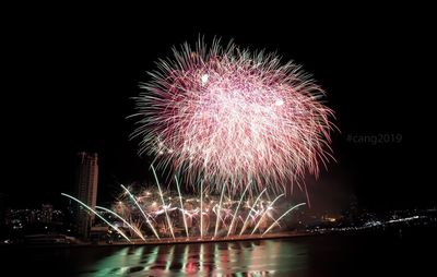 Firework display over city at night