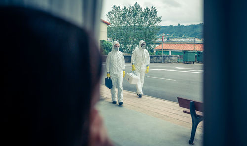 Doctors walking on footpath in city