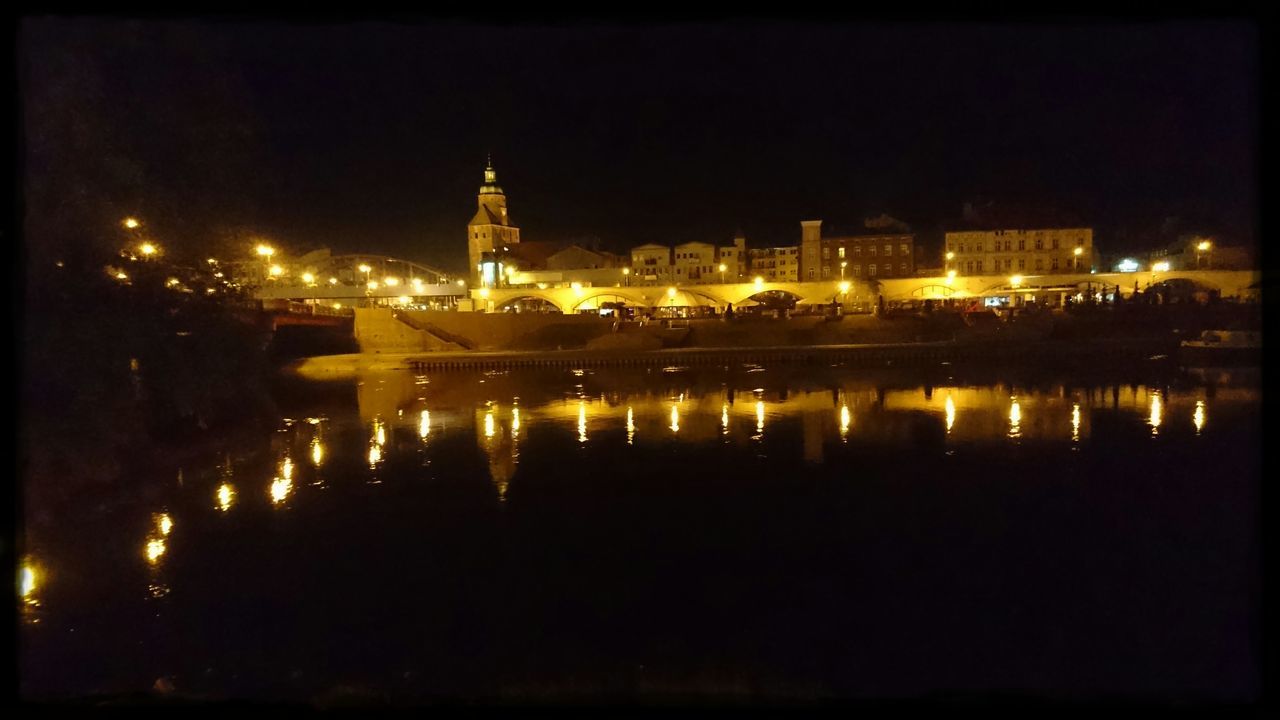 illuminated, night, architecture, water, building exterior, built structure, reflection, city, river, waterfront, cityscape, sky, clear sky, dark, sea, travel destinations, nautical vessel, copy space, outdoors, no people