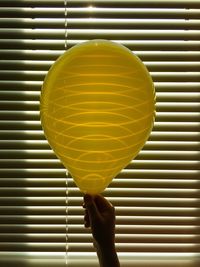 Close-up of person holding balloons