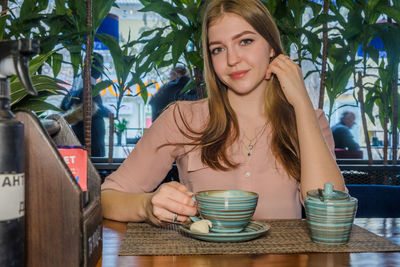 Portrait of young woman at cafe