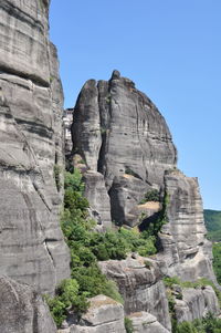 Low angle view of cliff against clear sky