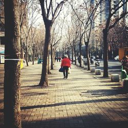 Rear view of people walking on footpath