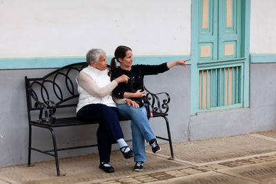 Senior mother and adult daughter traveling together at the small town of salento in colombia