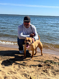Side view of dog running at beach