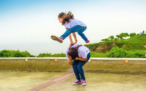 Full length of woman jumping in mid-air