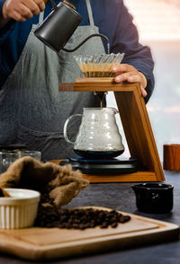 Man pouring coffee in cup