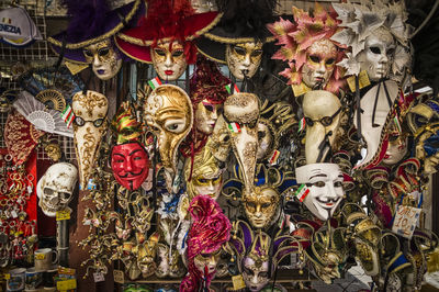 Various masks hanging at market stall