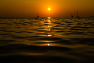 Silhouette man swimming in sea during sunset