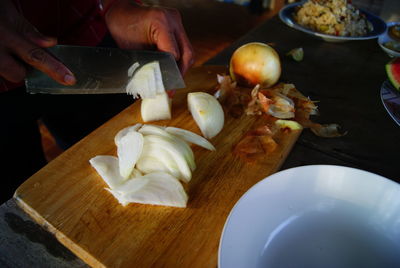 Person preparing food on cutting board