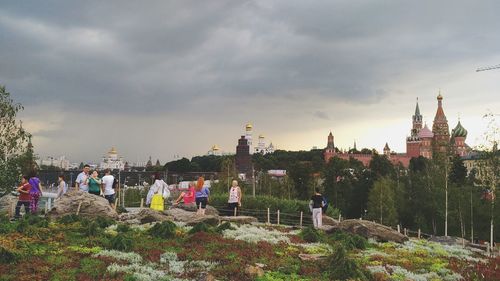 Panoramic view of crowd and buildings against sky