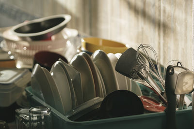 Close-up of utensils in bucket on kitchen counter at home