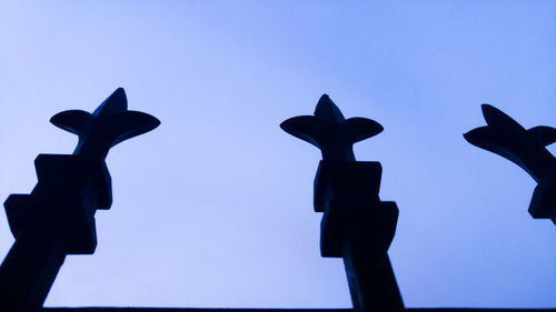 Low angle view of silhouette statue against clear sky