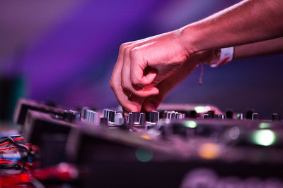 Cropped hand of musician adjusting audio equipment