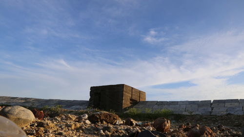 Group of people on built structure against blue sky