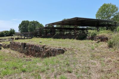 Abandoned building on field against sky