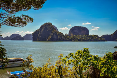 Scenic view of rocky mountains and sea against sky in thailand