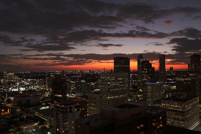 High angle view of illuminated buildings against sky during sunset