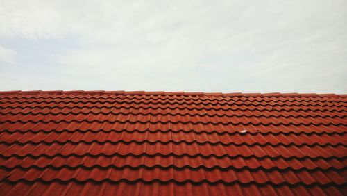 Red roof tiles against sky