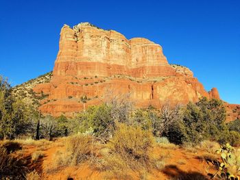 View of rock formation against clear blue sky