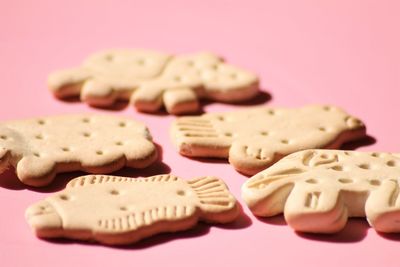 Close-up of cookies over pink background