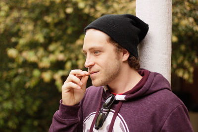 Close-up of smiling young man using toothpicks