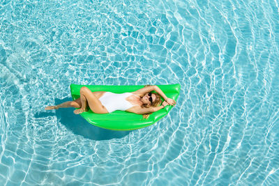Woman lying down in swimming pool