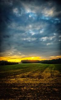 Scenic view of field against sky during sunset