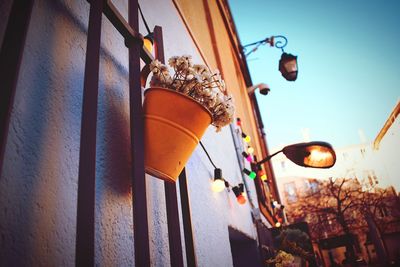 Low angle view of illuminated lanterns hanging by building