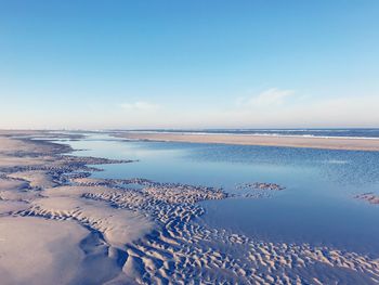 Scenic view of sea against sky during winter