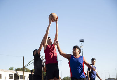 Teenagers playing basketball