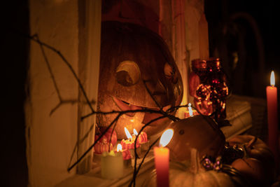 Lit candles in dark room