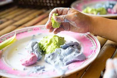 Close-up of person preparing food on table