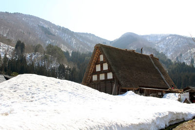 Snow covered landscape against sky